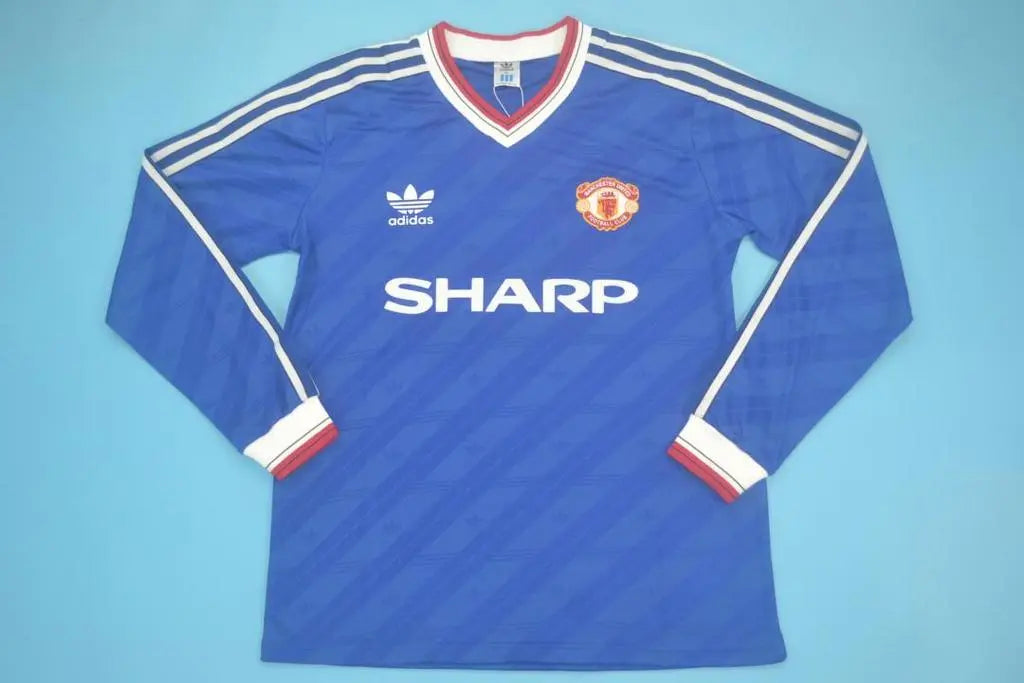 MAILLOT RETRO MANCHESTER UNITED EXTÉRIEUR 1986/1988 VERSION MANCHES LONGUES - MODAFOOT